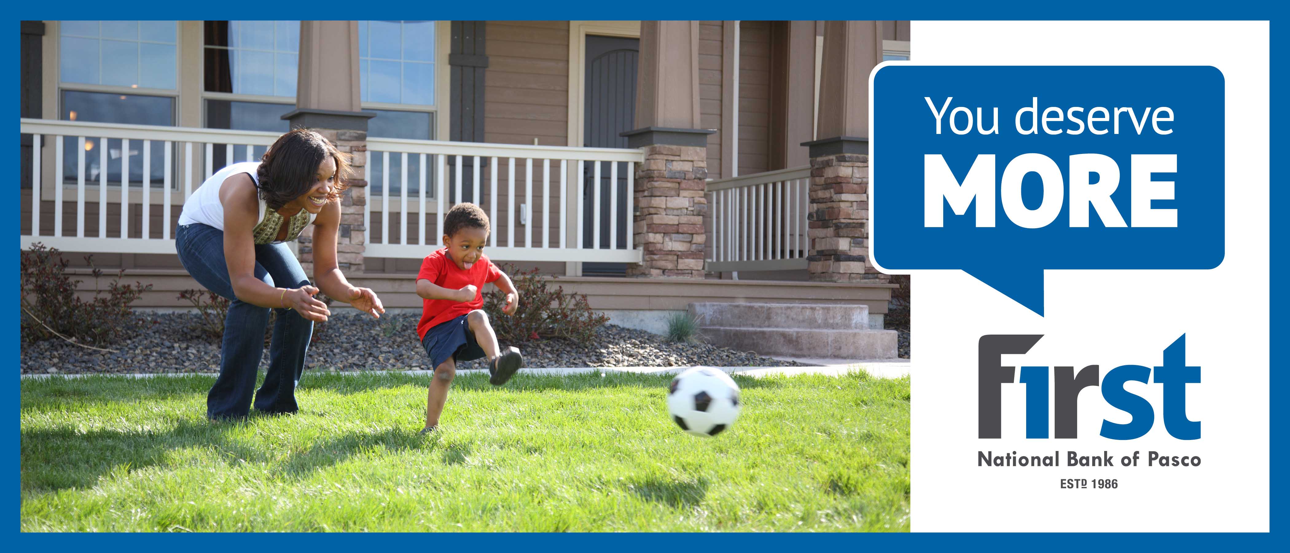 Young Child and Mother Playing with Ball in Front Yard